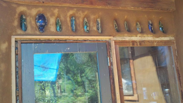 Bottle window in the cob wall add some fun light effects inside, natural building